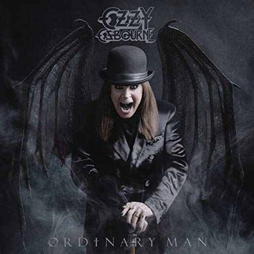 Ozzy Osbourne wearing a bowler hat and dark wings against a smoky background.