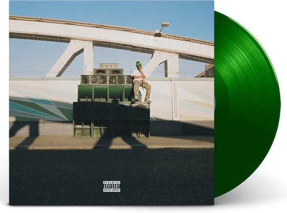 Vinyl record cover with a person on stacked speakers, green disc shown.