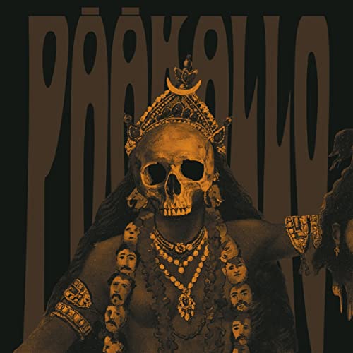 A skull-headed figure wearing a crown and a necklace of small human heads.