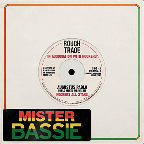 White vinyl record label with red and green text, central black spindle hole.