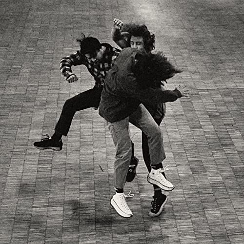 Black and white photo of two people struggling in a dance-like pose.