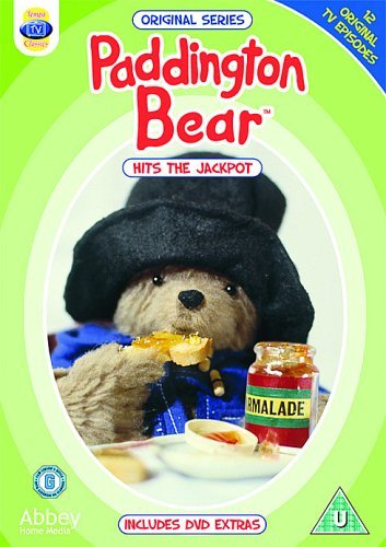 Paddington Bear wearing a hat and blue coat, eating toast with marmalade on DVD cover.