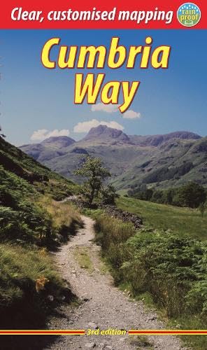 A hiking trail leads through a grassy landscape toward distant mountains under a blue sky.