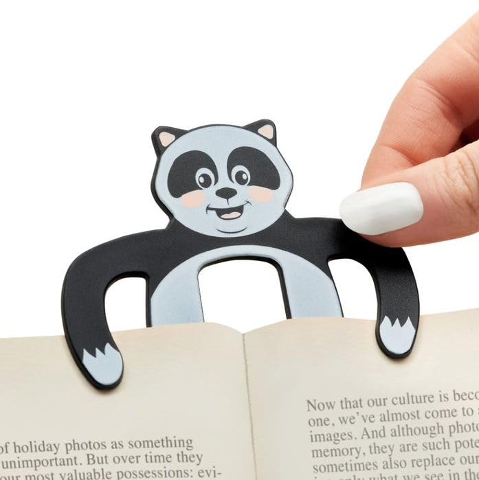 Black and white panda-shaped magnetic bookmark resting on an open book.