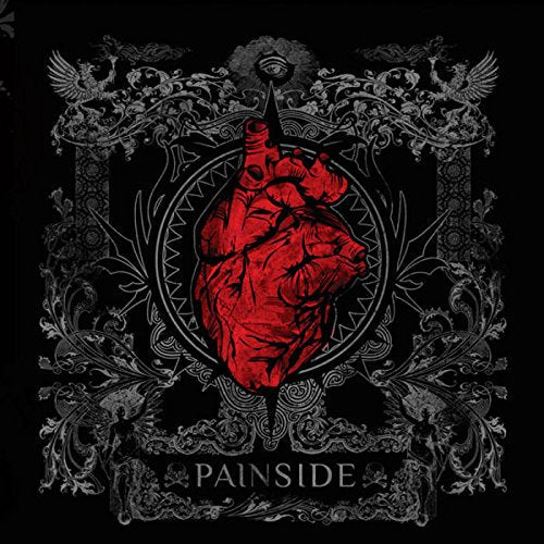 Red anatomical heart within ornate, dark gray and black decorative frame.