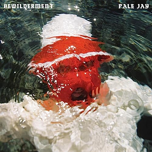 CD cover: a person’s face partially submerged in rippling water.