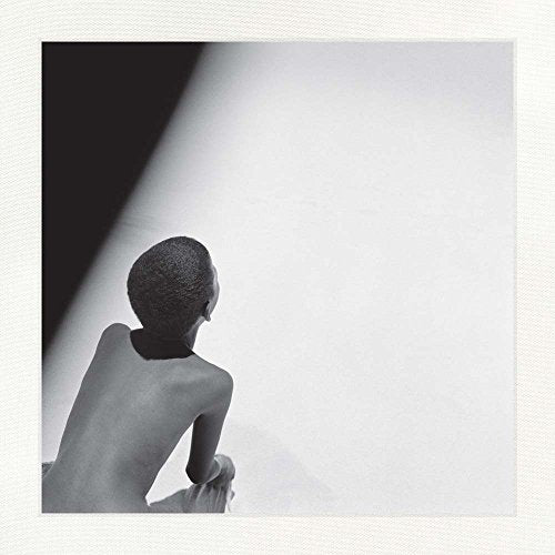 Black and white photo of a person’s back, facing away from the viewer.