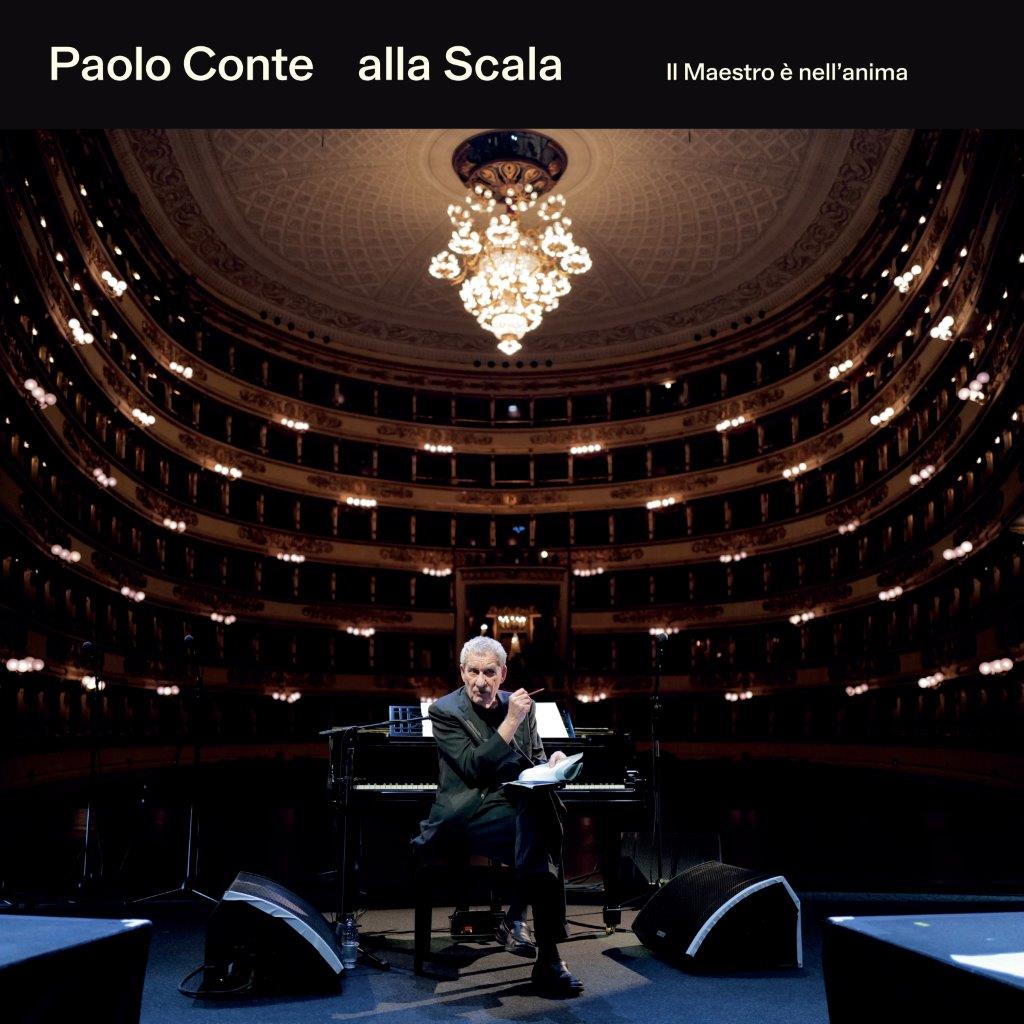 Paolo Conte at a piano on stage in the ornate La Scala opera house.