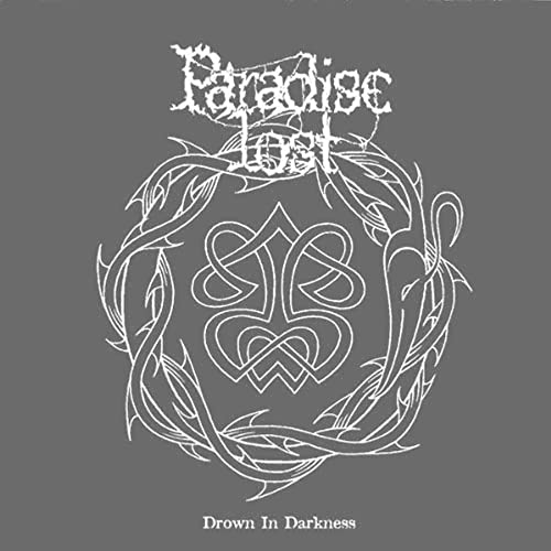 Paradise Lost album cover, ornate white design on a dark gray background.