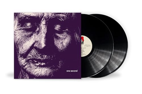 Purple album cover with a close-up face next to two black vinyl records.