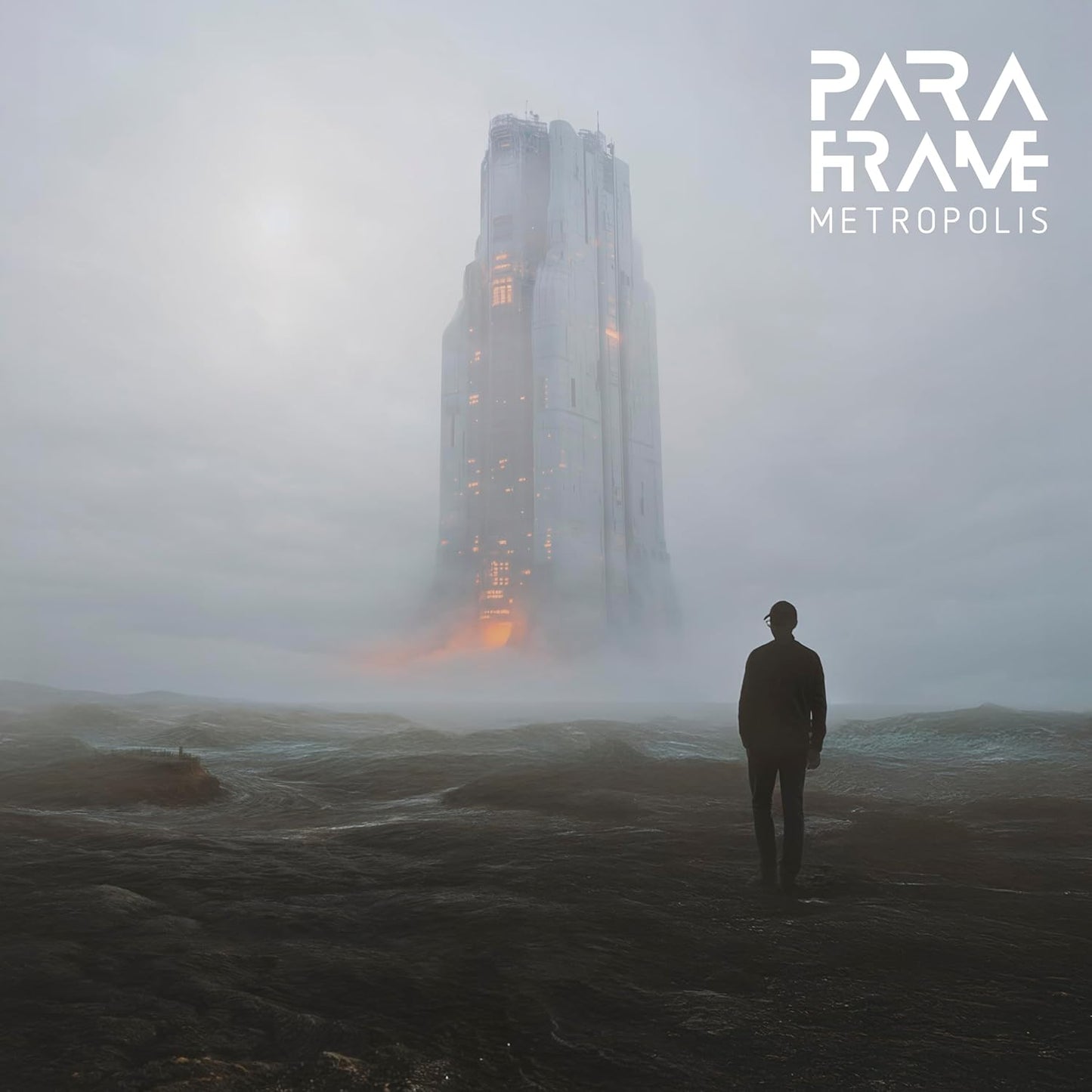 Silhouette of a person facing a tall, misty building.