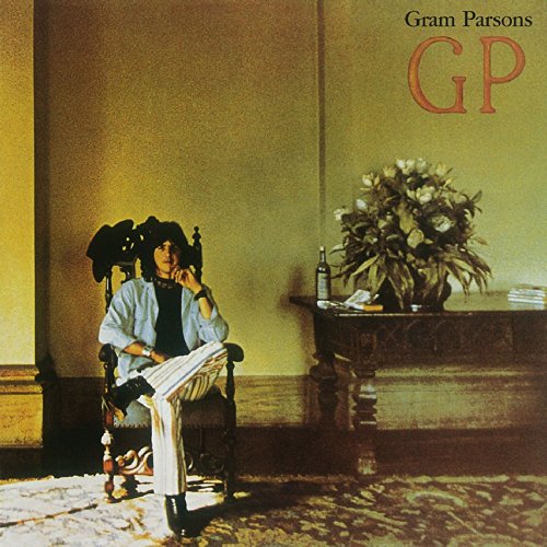 Vinyl record cover featuring Gram Parsons sitting in a chair, reading papers.