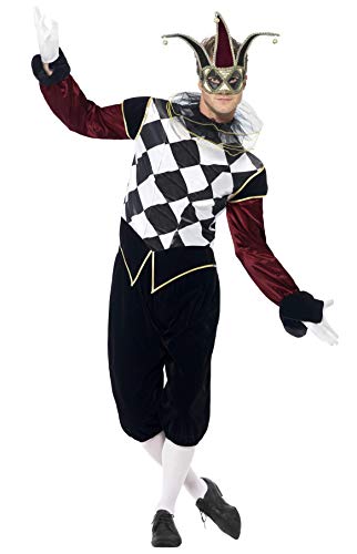 Man wearing a black and white harlequin costume with a jester’s hat.