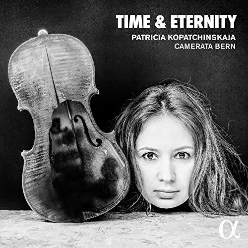 Black and white image of a woman with a violin on a surface.