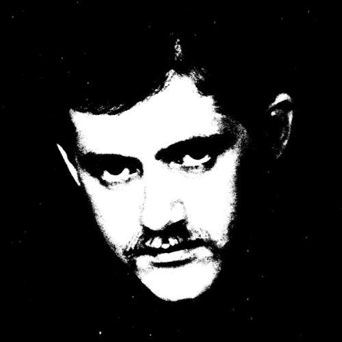 Black and white close-up portrait of a man with a serious expression.