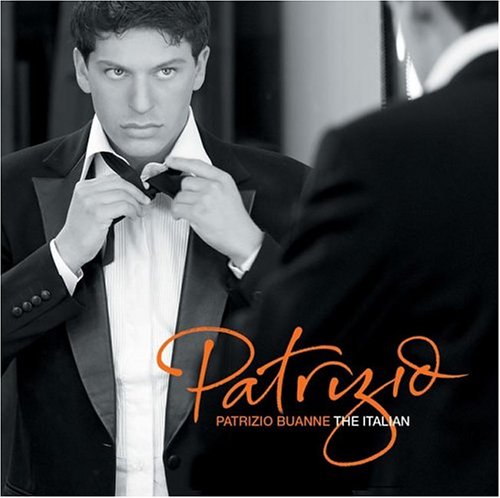Black and white portrait of Patrizio Buanne adjusting his bow tie.