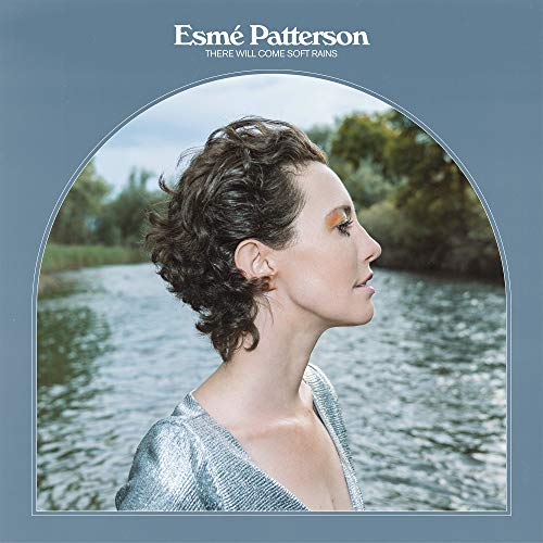 Album cover with a woman in a silver top, facing right, against a water backdrop.