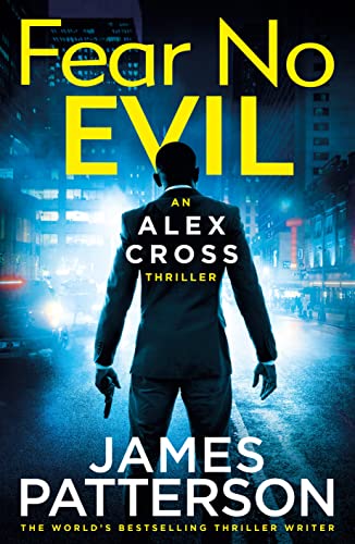 Book cover: man in suit with gun, city lights background.