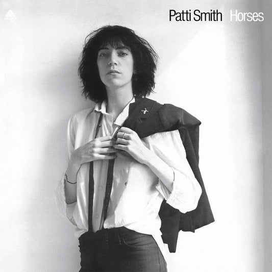 Black and white album cover featuring Patti Smith in a jacket and shirt.
