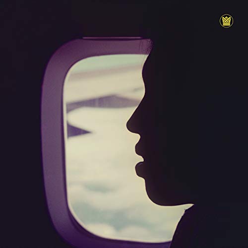 Silhouette of a face looking out an airplane window.
