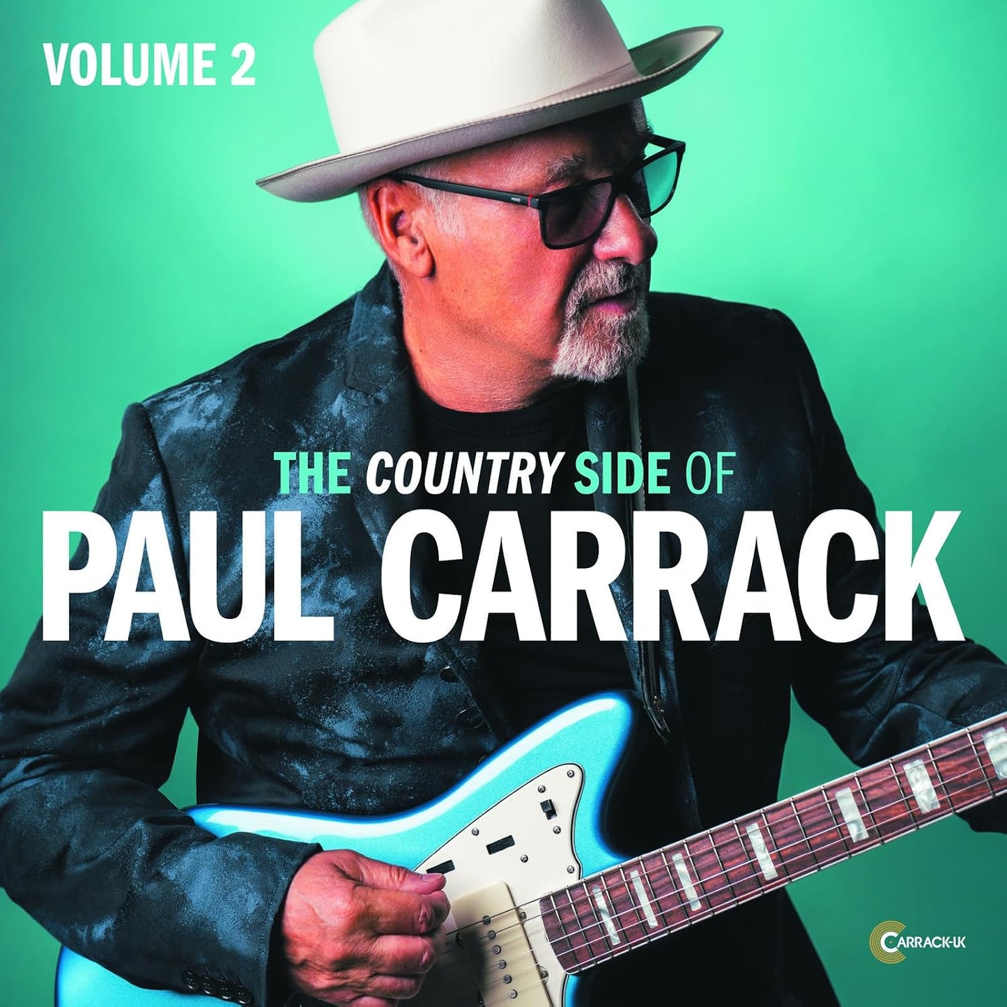Paul Carrack album cover, featuring him with a guitar and hat.