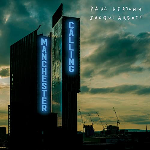 CD cover: Tall building with illuminated “Manchester Calling” sign, stormy sky.