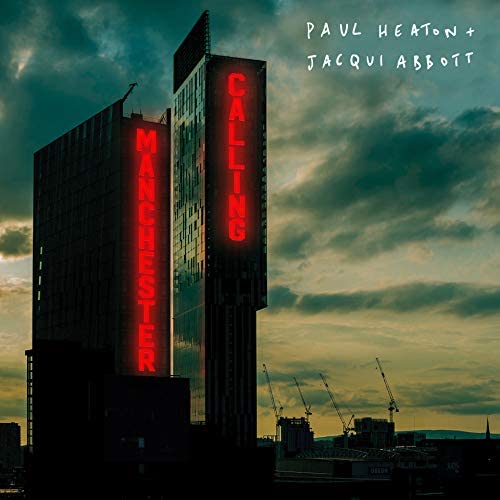 "CD album cover featuring a building with 'Manchester Calling' in red neon lights."