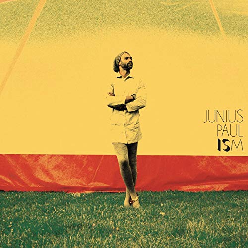 CD cover for Junius Paul’s “ISM” featuring a man against a colorful backdrop.