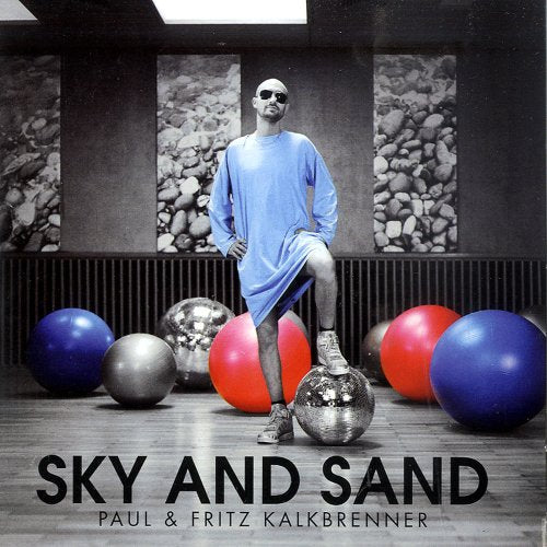 Paul Kalkbrenner album cover with a man, colorful spheres, and text.