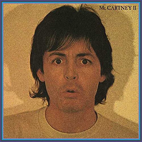 Paul McCartney album cover: close-up portrait with textured gold background.