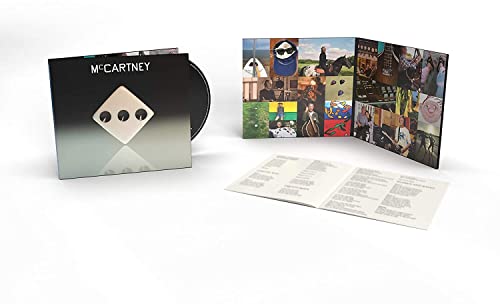 Paul McCartney III CD case with dice cover, open gatefold sleeve, and lyric booklet.