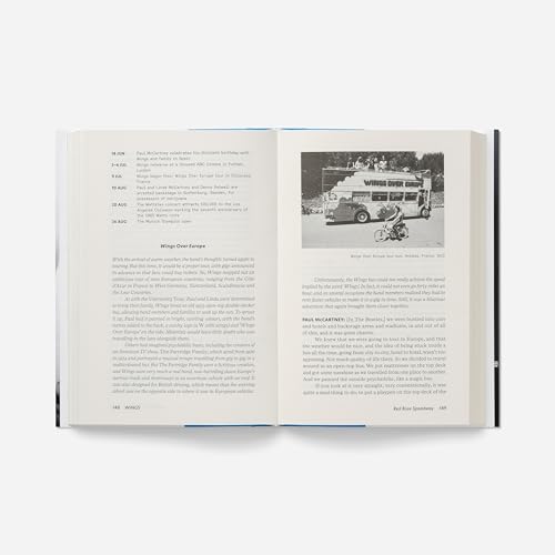 Open book displaying photos of Wings band members and tour bus.
