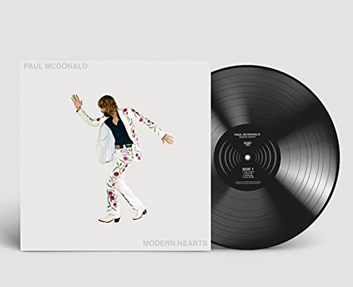 Paul McDonald album cover featuring a man in a floral suit next to vinyl.