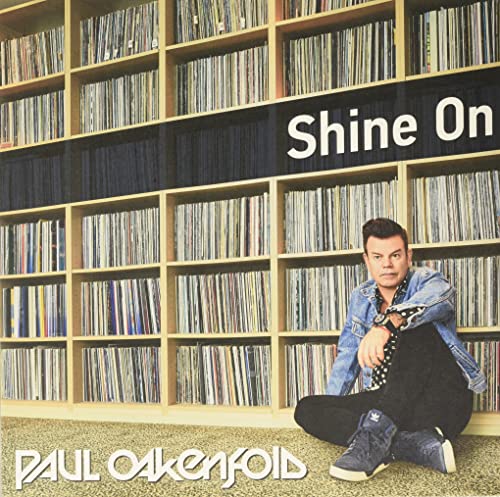 Paul Oakenfold album cover, "Shine On", with artist seated before records.