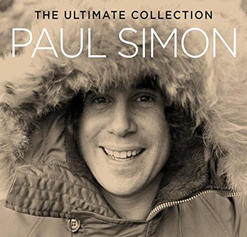 Paul Simon smiling, wearing a fur-lined parka hood, in a sepia-toned album cover portrait.