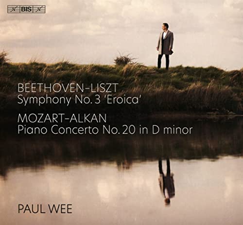 CD cover featuring a man standing on a grassy hill by water.