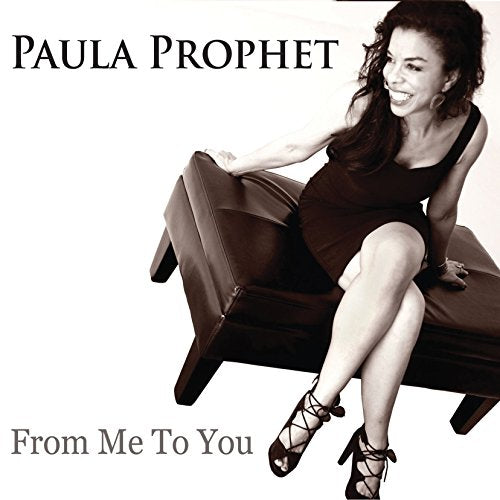 Paula Prophet album cover: smiling woman in a black dress on a bench.