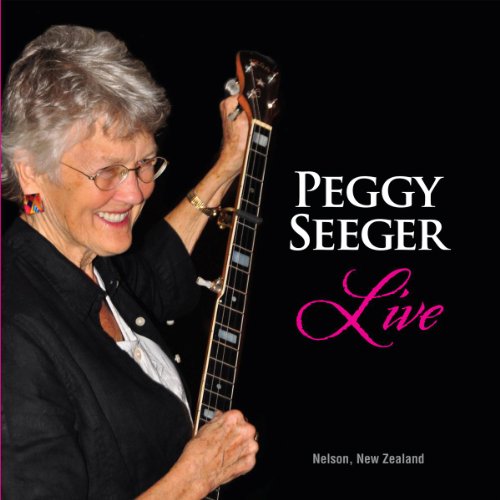 Peggy Seeger smiles, holding a guitar, album cover for “Live”.