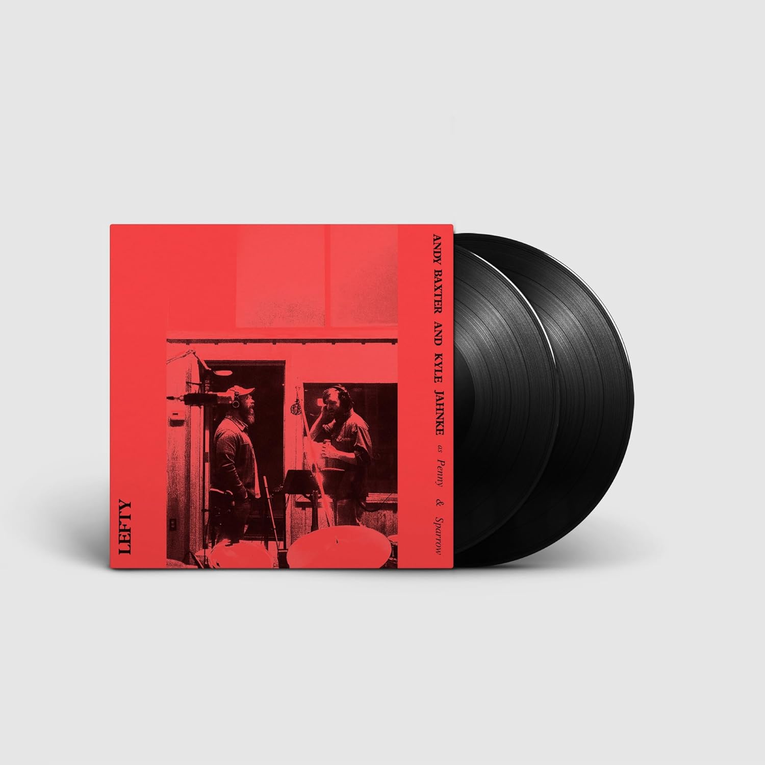 Red vinyl record with black discs and a black and white photograph.