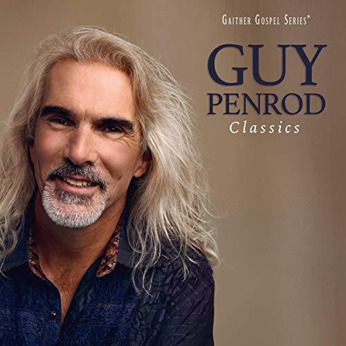 Guy Penrod smiling, with long blond hair and a dark blue collared shirt.