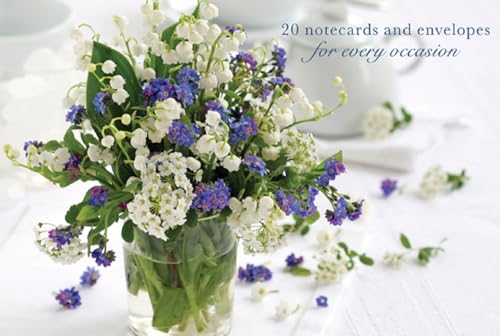 Bouquet of white and blue forget-me-not flowers in a glass jar.
