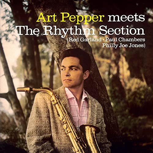 Art Pepper holding a saxophone, leaning against a tree, album cover art.