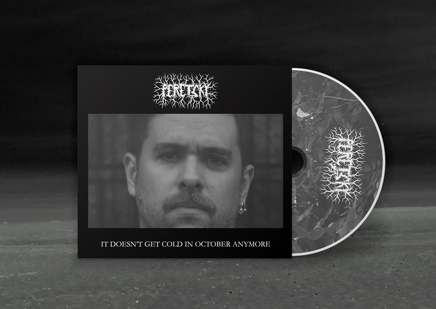 Vinyl record and CD packaging featuring a black and white portrait of a man.