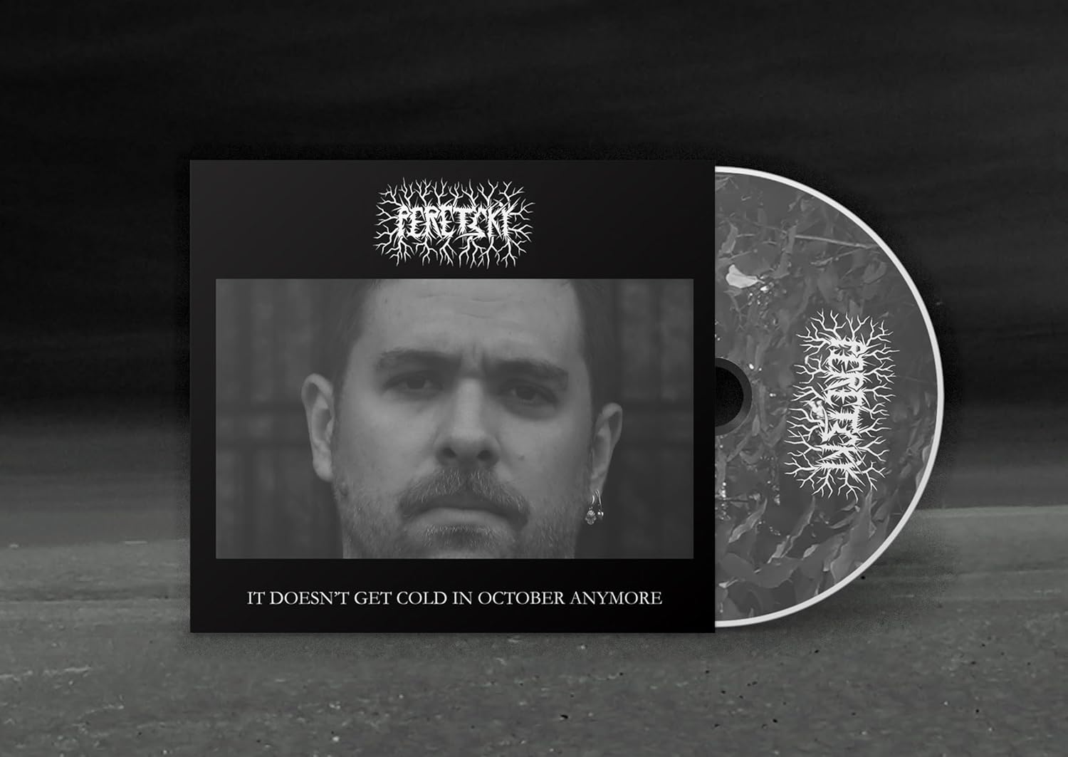 Vinyl record and CD packaging featuring a black and white portrait of a man.