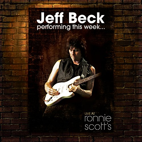 Jeff Beck playing white guitar on Blu-ray cover, brick background.