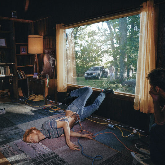 Album cover for Perfume Genius' "Glory" featuring a person lying indoors.