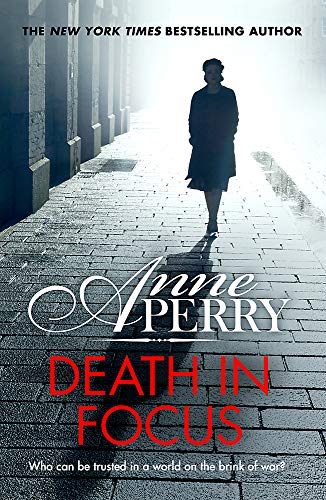 Book cover: woman walking down a brick street, title “Death in Focus”.