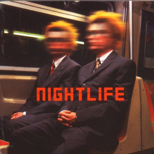 Two men in suits with motion-blurred faces sit on a subway train.