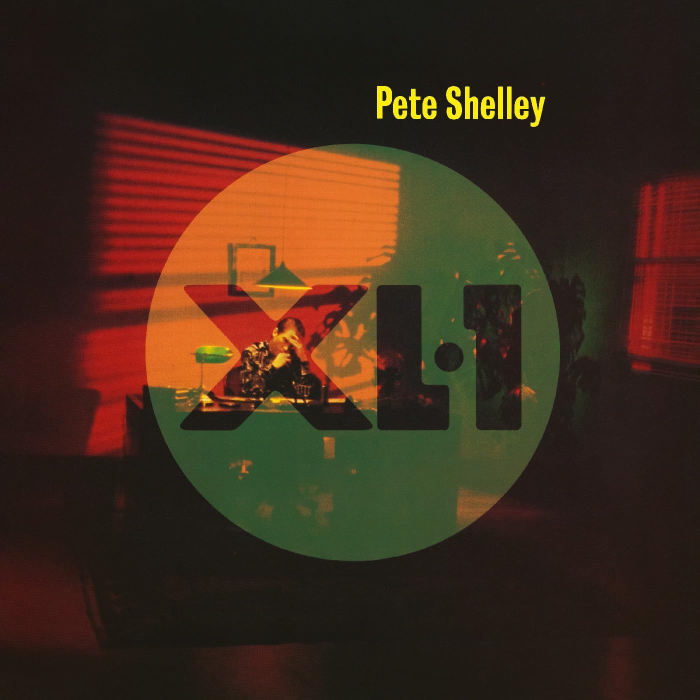 Album cover for Pete Shelley XL/1 featuring a man sitting at a desk.