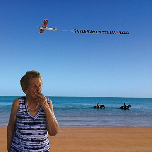 An elderly woman smokes on a beach while a plane pulls an advertising banner.